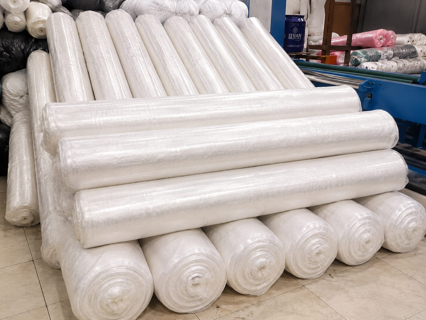 Neatly stacked finished fabric rolls
